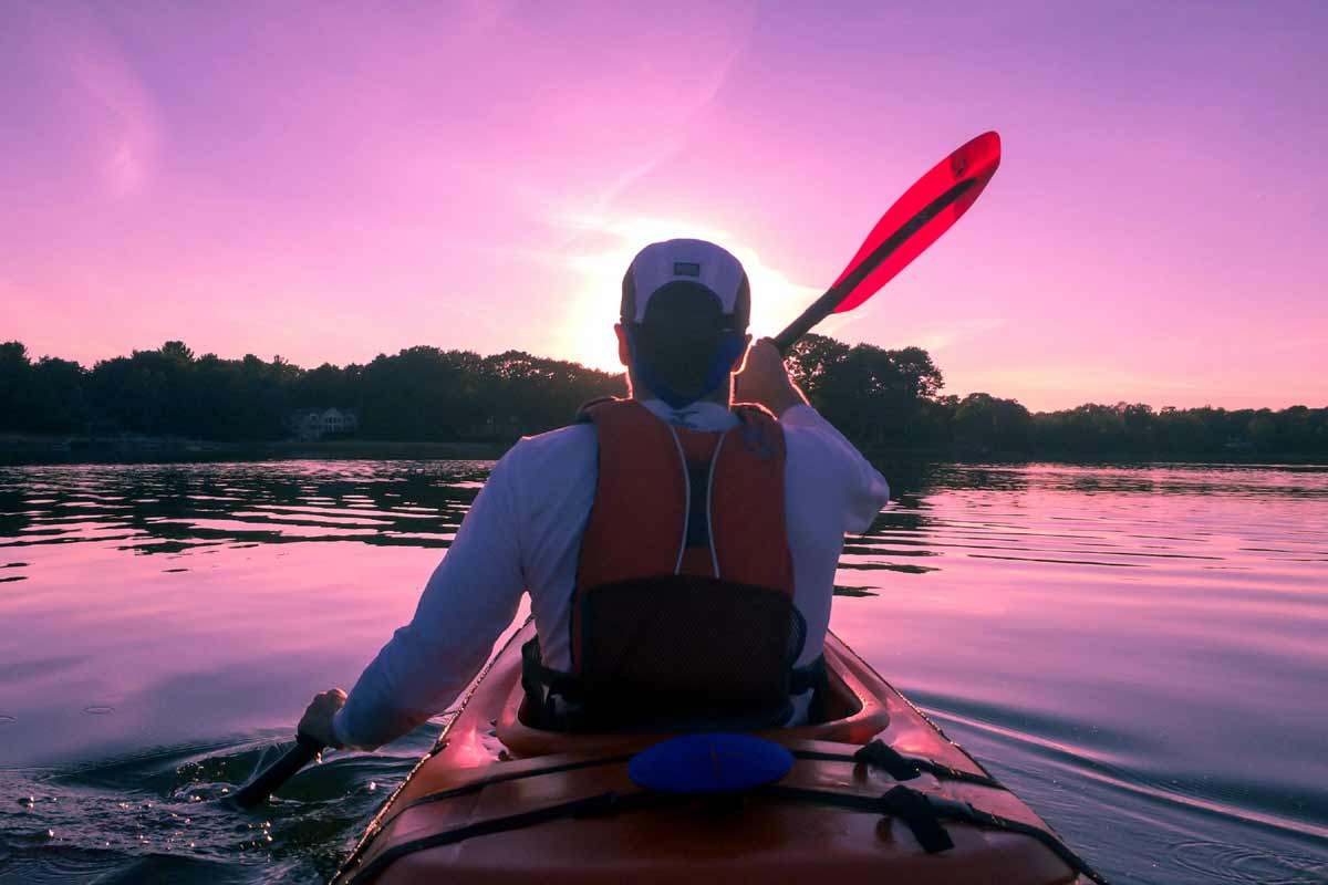 man kayaking in water